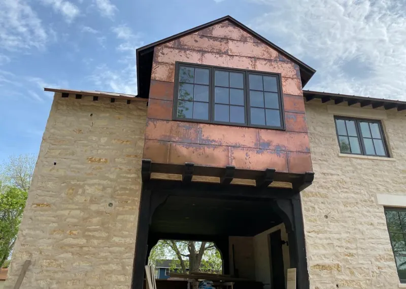 Copper metal panel facade on a stone building for Skylight Installation in Rolesville