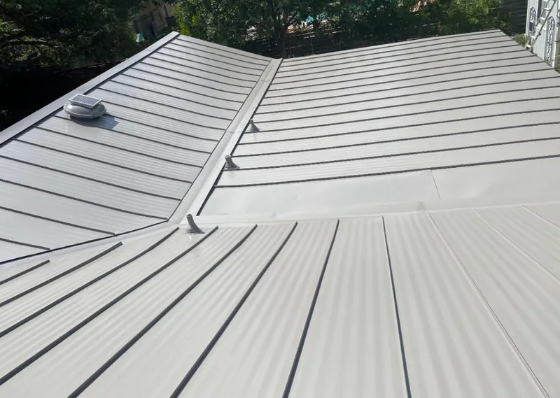 Solar attic fan installed on a metal roof for Roof Ventilation in Rolesville